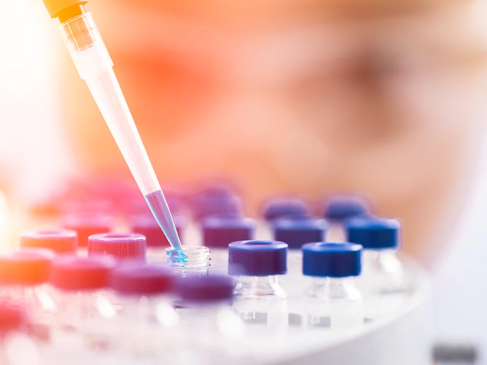 A researcher working with pipettes in a lab